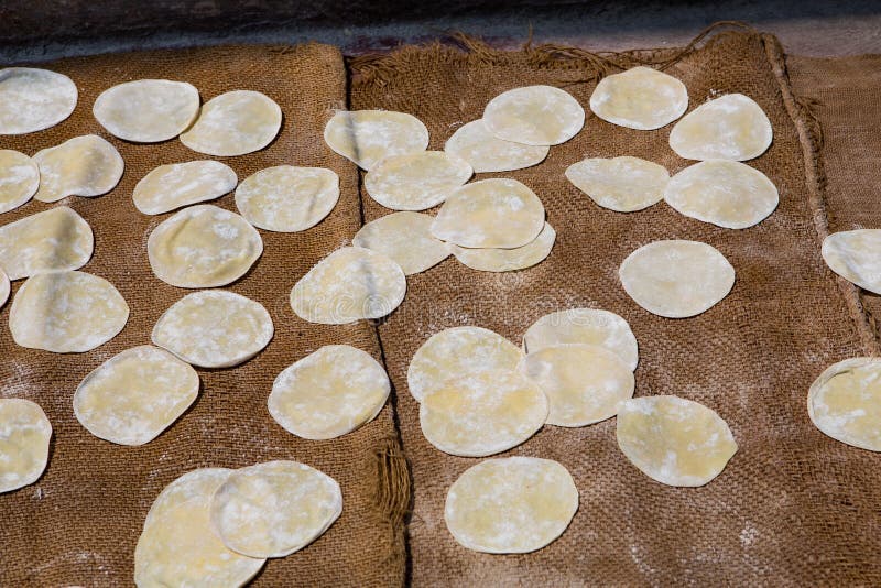 Preparing dough for baking naan bread in the south of india. The naan breads lie on burlap bags. Preparing dough for baking naan bread in the south of india. The naan breads lie on burlap bags