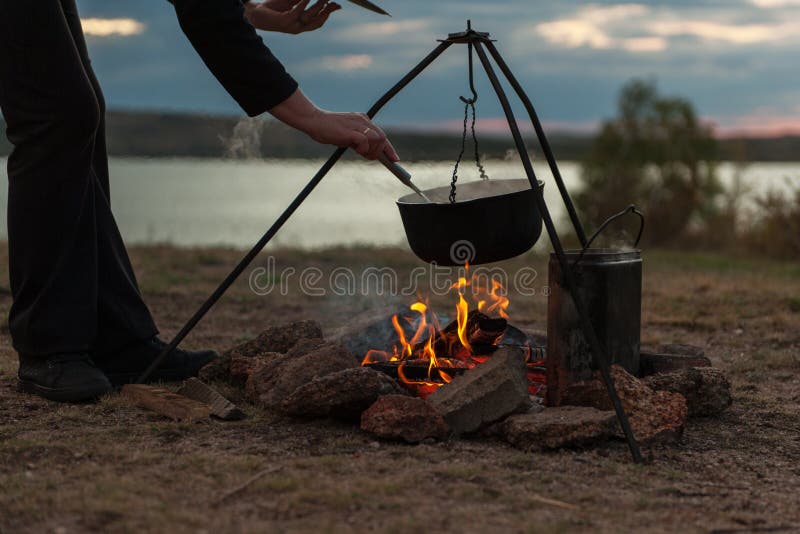 Preparing food on campfire.