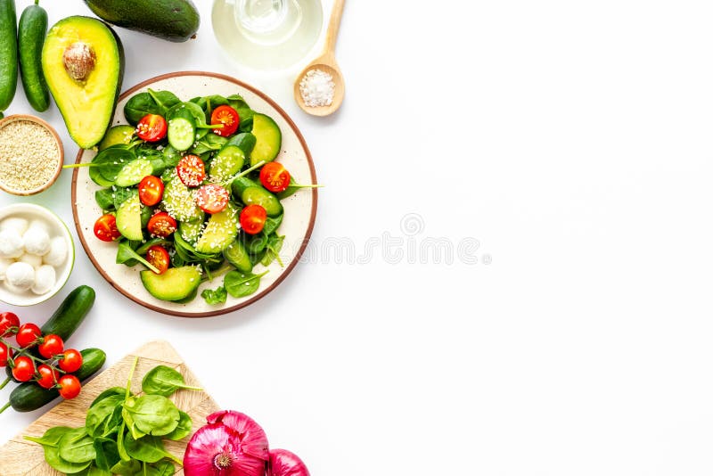 Preparing Fresh Salad. Vegetables, Greens, Spices on White Background Top View Copy Space Stock