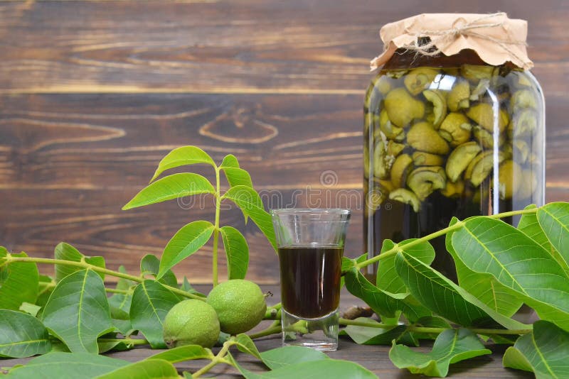 Preparing green walnut liqueur stock images