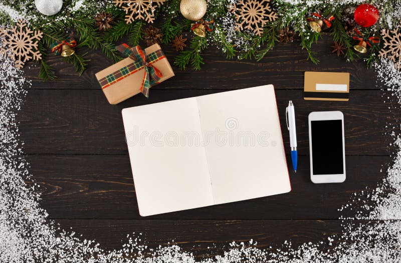 Christmas wishlist, gift box, phone and credit card on wooden background, top view, flat lay.