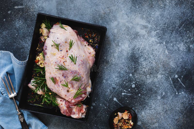 Preparing a meat roast leg of lamb marinated with herbs and garlic