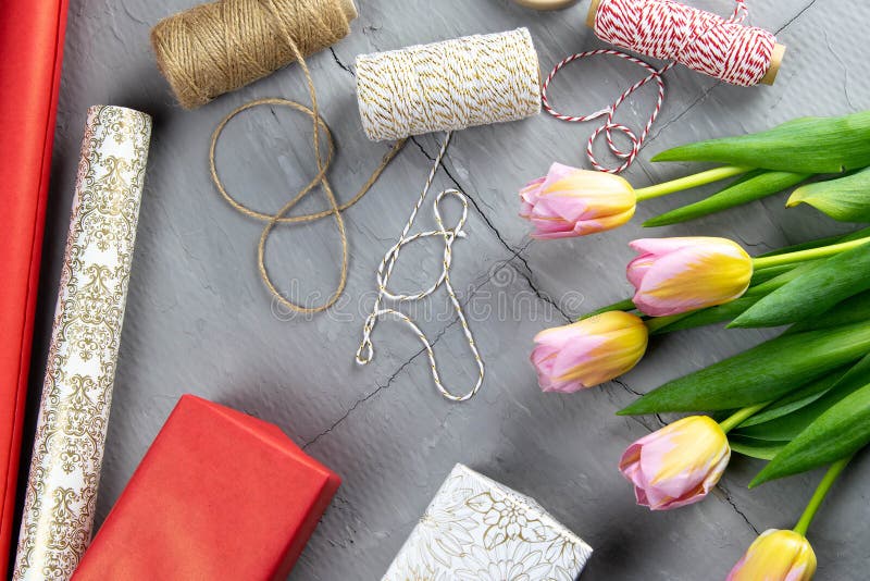 Preparing for the Packaging of Gifts, on the Table Laid Out Red and White Wrapping Paper