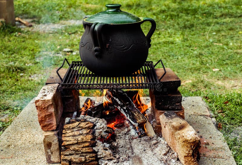 Preparing Romanian Traditional Food in Clay Dishes an Open Fire Stock