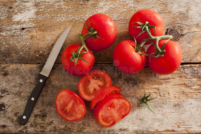 Preparing sliced ripe red tomatoes