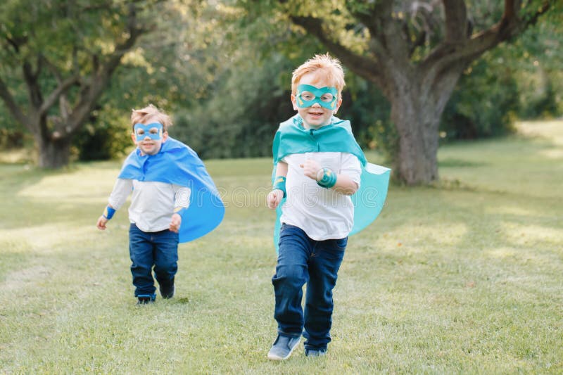 Preschool Caucasian children playing superheroes stock image Preschool Caucasian children playing superheroes stock image