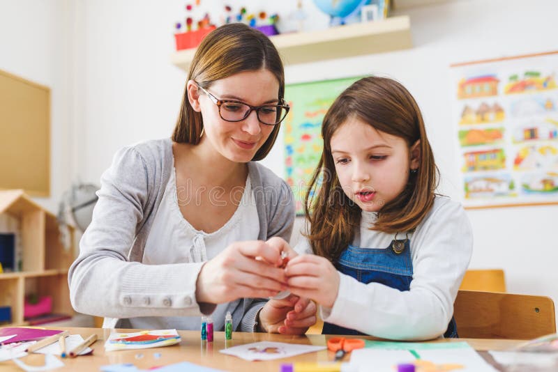 Preschool teacher with child at Kindergarten - Creative Art Class stock images