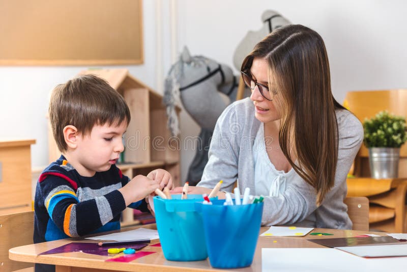 Preschool teacher with child at Kindergarten - Creative Art Class stock images