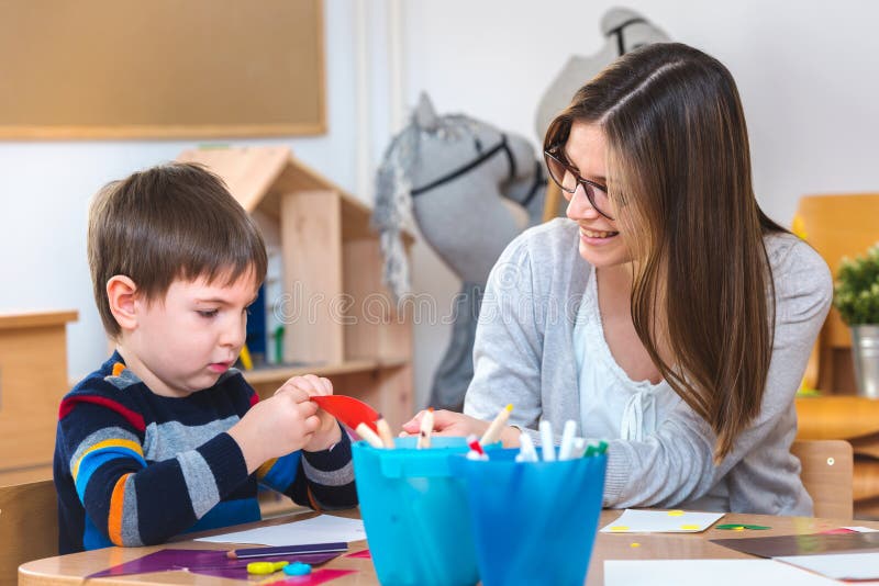 Preschool teacher with child at Kindergarten - Creative Art Class stock image
