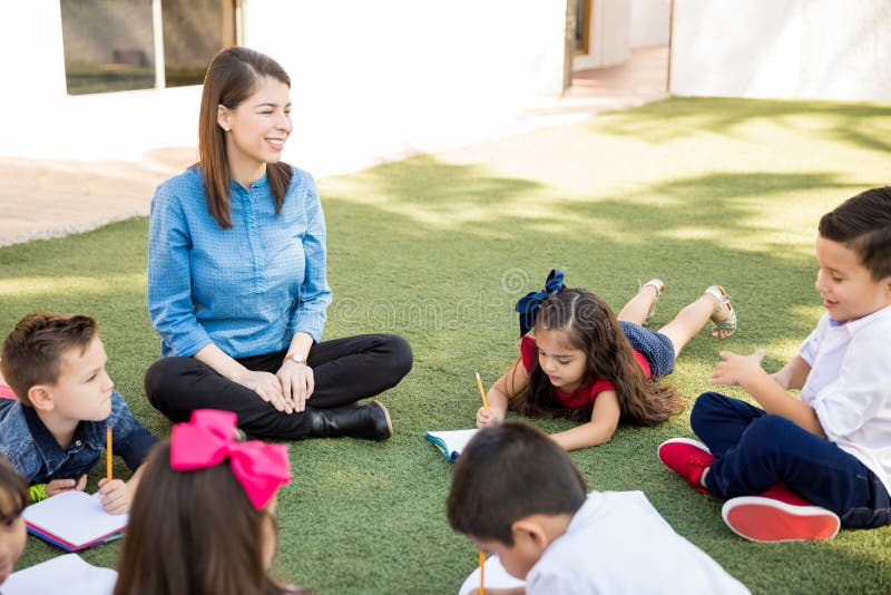 Preschool teacher taking students outside stock image Preschool teacher taking students outside stock image