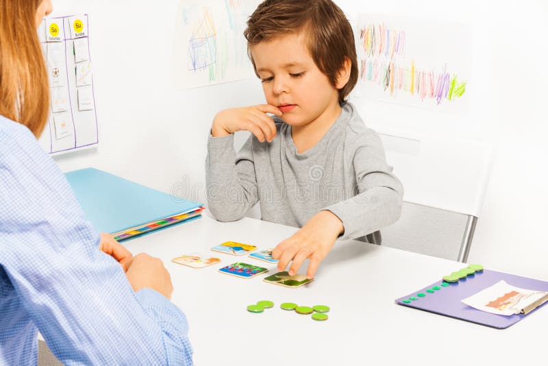 Preschooler boy and developing game with card