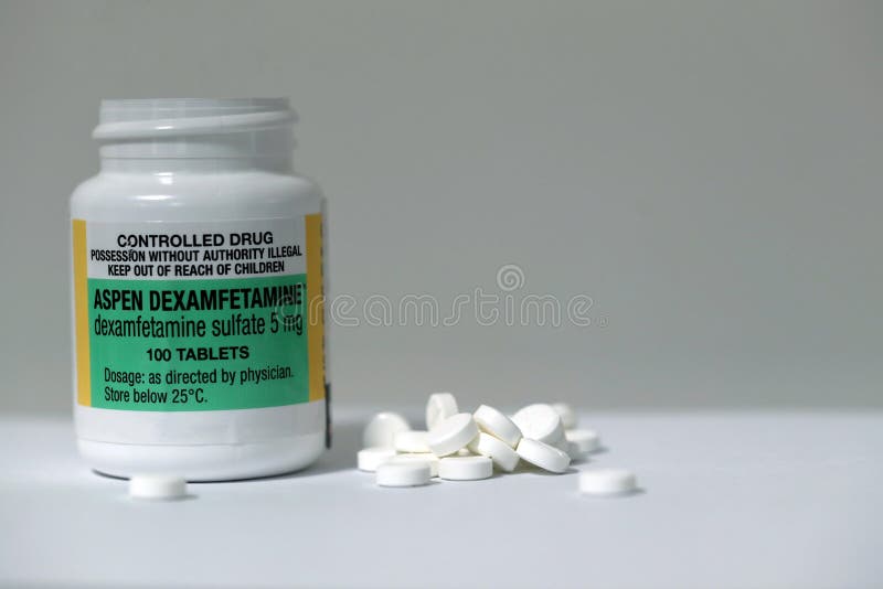 Prescription Attention Deficit Hyperactivity Disorder ADHD legal drug bottle container and contain 100 tablets on the white table. Prescription Attention Deficit Hyperactivity Disorder ADHD legal drug bottle container and contain 100 tablets on the white table