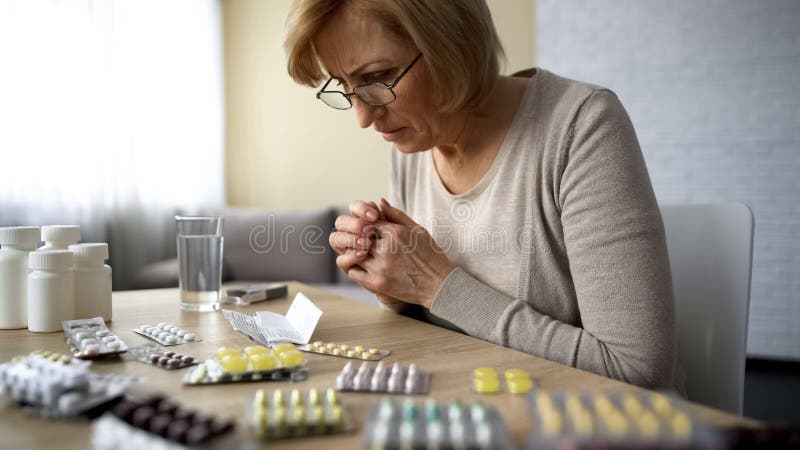 Prescripción de la lectura de la mujer, efecto secundario de la medicación, apego de la enfermedad de la edad avanzada imagenes de archivo Prescripción de la lectura de la mujer, efecto secundario de la medicación, apego de la enfermedad de la edad avanzada imagenes de archivo