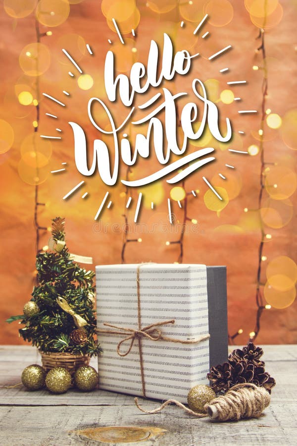 Present Box with Christmas Decorations and Bokeh Lights on a Wooden