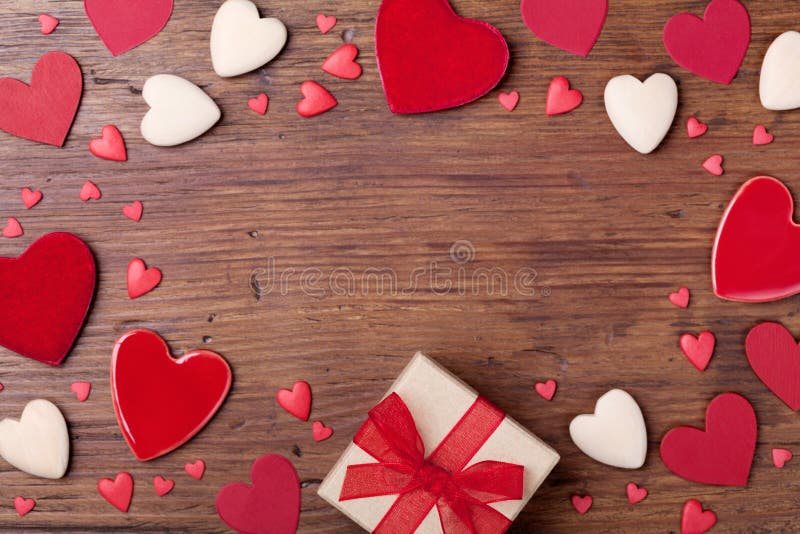 Present or gift box and mixed hearts for Valentines day frame. Top view. Holiday background with empty space for text. stock images Present or gift box and mixed hearts for Valentines day frame. Top view. Holiday background with empty space for text. stock images