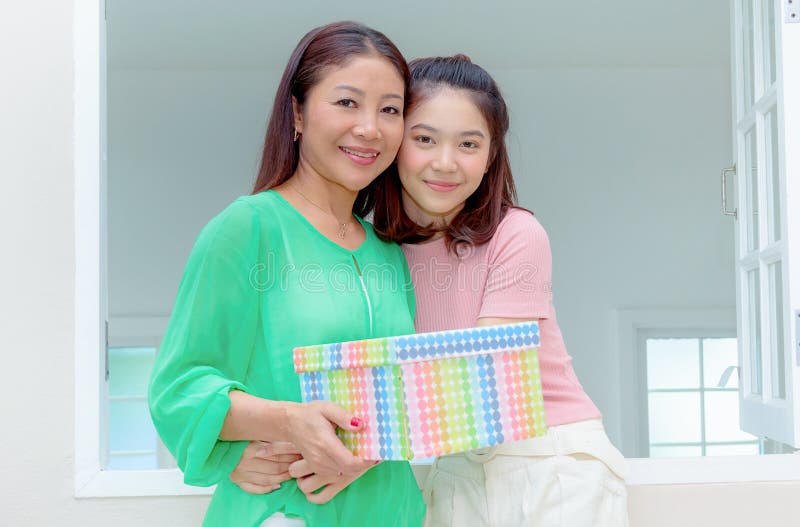 Present for mom,happy mother and young daughter hold present for stock images Present for mom,happy mother and young daughter hold present for stock images