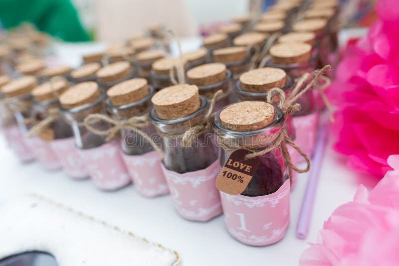 Wedding gift at an outdoor wedding party, honey in the bottles. Wedding gift at an outdoor wedding party, honey in the bottles