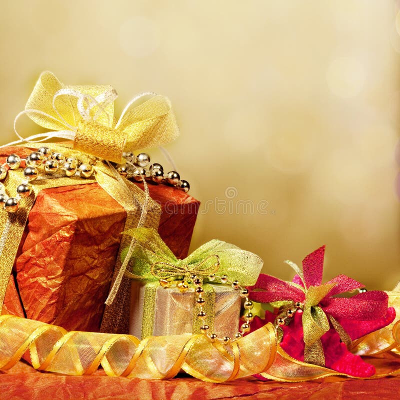 Decoratively wrapped presents or gifts with luxurious ribbons; light background and copy space. Decoratively wrapped presents or gifts with luxurious ribbons; light background and copy space.