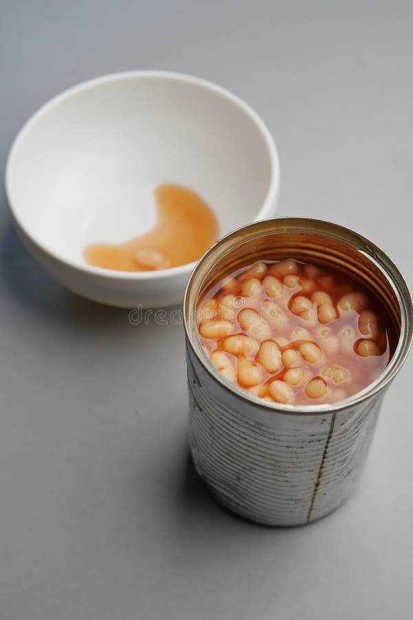 Preserved Canned Tomato Beans Pouring into a Bowl Stock Photo Image
