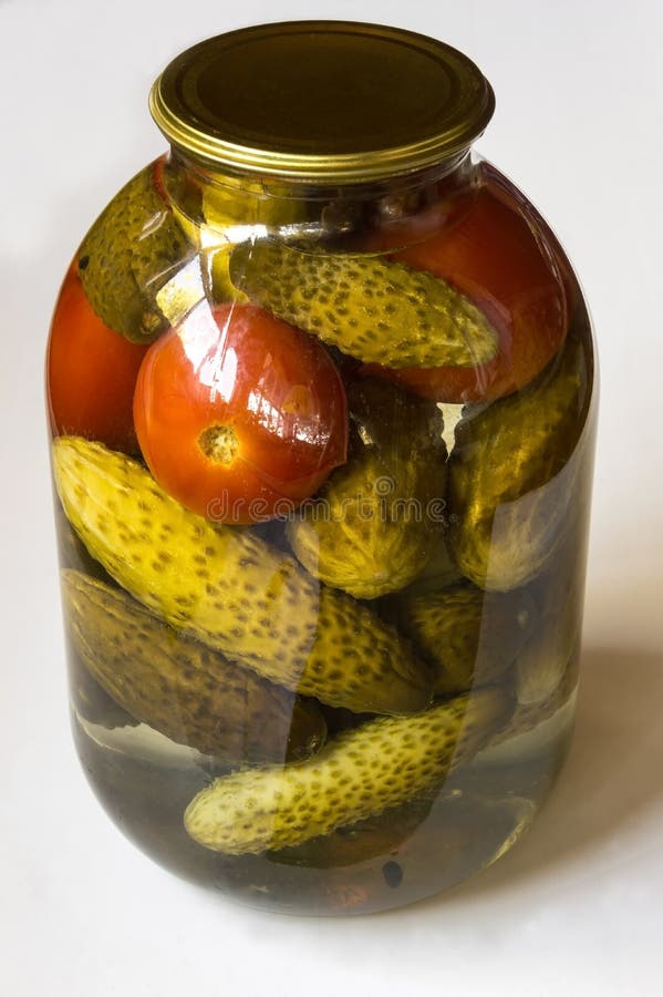 Preserving. Preparations for the winter. Pickles and tomatoes in a glass jar. royalty free stock photos Preserving. Preparations for the winter. Pickles and tomatoes in a glass jar. royalty free stock photos