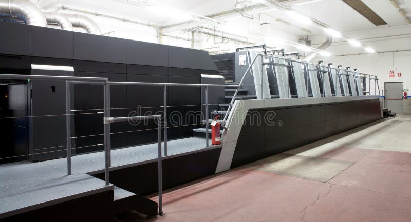 Press printing - Offset machine. Printing technique where the inked image is transferred from a plate to a rubber blanket, then to royalty free stock image