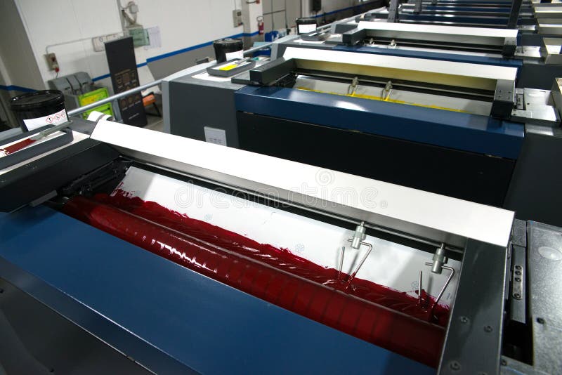 Press printing - Offset machine. Printing technique where the inked image is transferred from a plate to a rubber blanket, then to stock photos