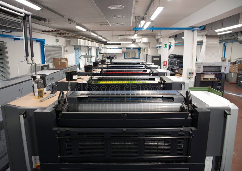 Press printing - Offset machine. Printing technique where the inked image is transferred from a plate to a rubber blanket, then to stock photos