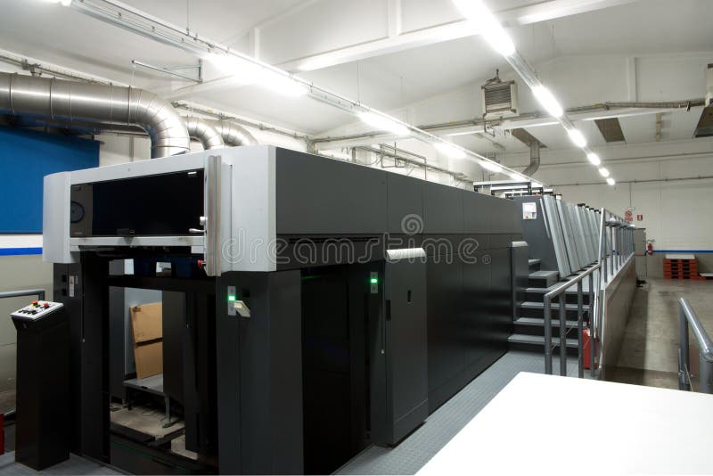 Press printing - Offset machine. Printing technique where the inked image is transferred from a plate to a rubber blanket, then to stock photo