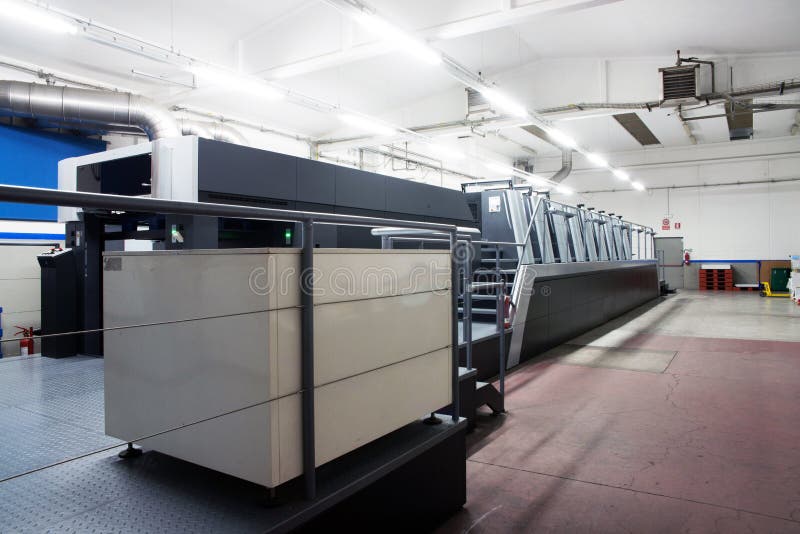 Press printing - Offset machine. Printing technique where the inked image is transferred from a plate to a rubber blanket, then to royalty free stock photography