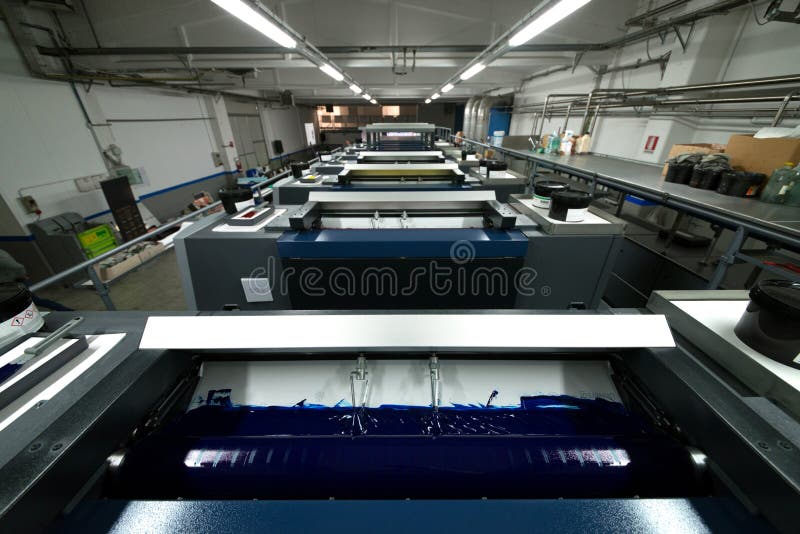 Press printing - Offset machine. Printing technique where the inked image is transferred from a plate to a rubber blanket, then to stock photos