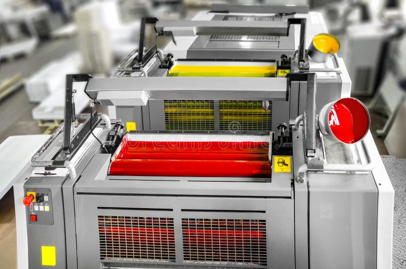 Press printing - Offset machine detail. Magenta and yellow units stock photo