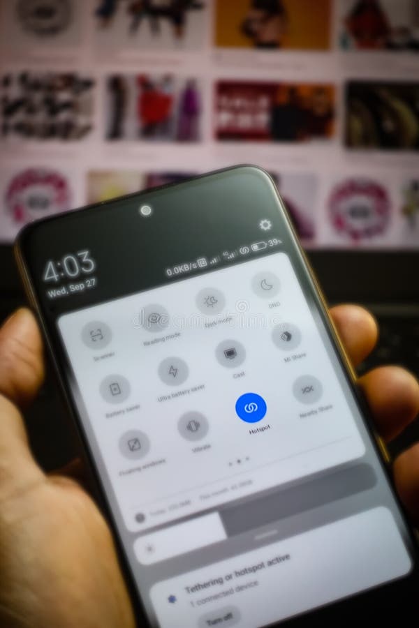 Pressing hotspot button in a mobile phone sharing the internet. stock photo