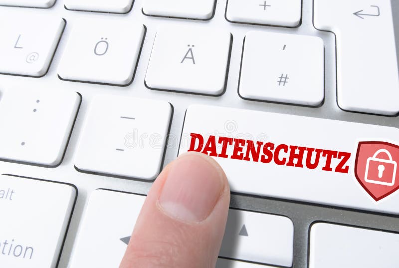Pressing key labeled DATENSCHUTZ, German for data privacy, on computer keyboardputer keyboard stock image