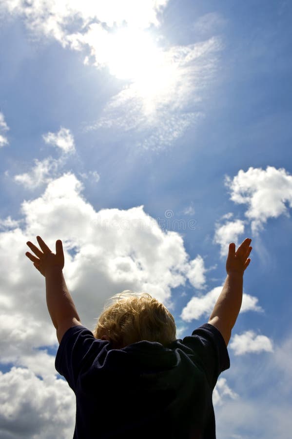 A young boy, with outstretched arms trying to reach for the sun, the source of life and our existence See more images that illustrate. A young boy, with outstretched arms trying to reach for the sun, the source of life and our existence See more images that illustrate