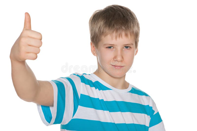 Preteen boy holds his thumb up