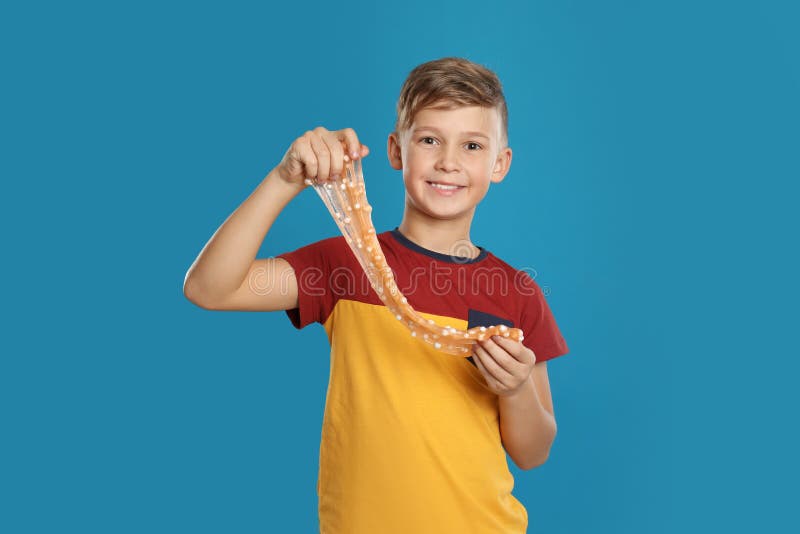 Preteen boy with slime on background