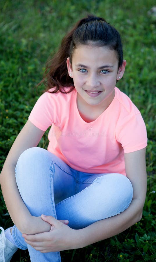 Preteen Girl With Blue Eyes Sitting On The Grass Stock Ph
