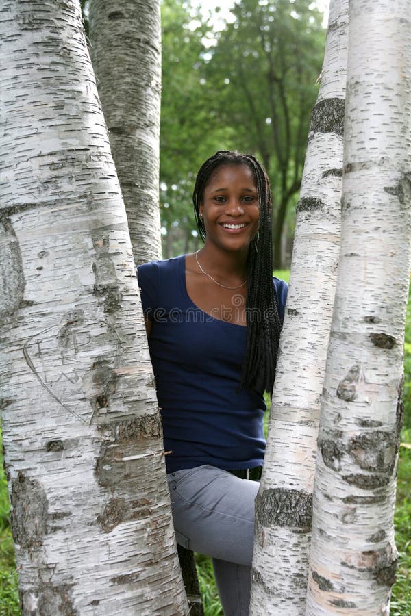 Pretty african american teen among birch trees