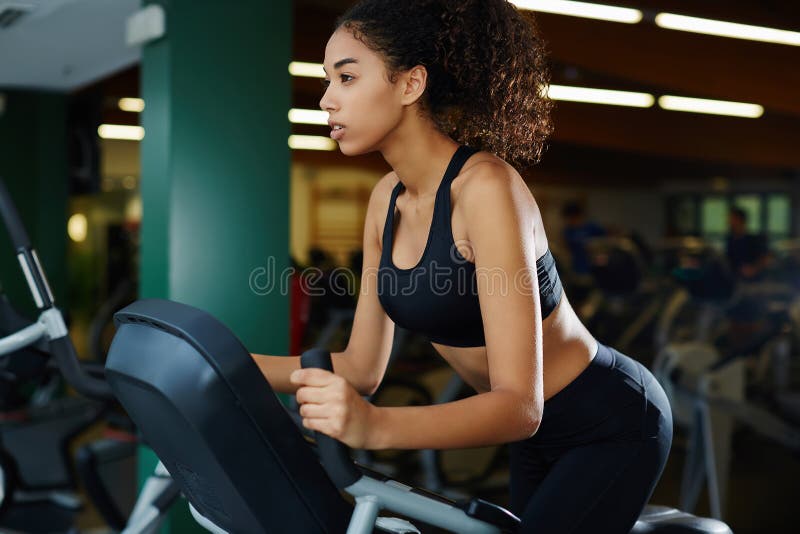 African American woman doing triceps exercises in the gym, close-up,  cardio, weight loss, beautiful Stock Photo by Gerain0812