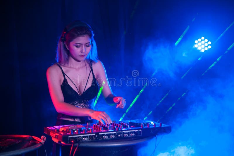 Pretty Asian female woman DJ playing music for dance.