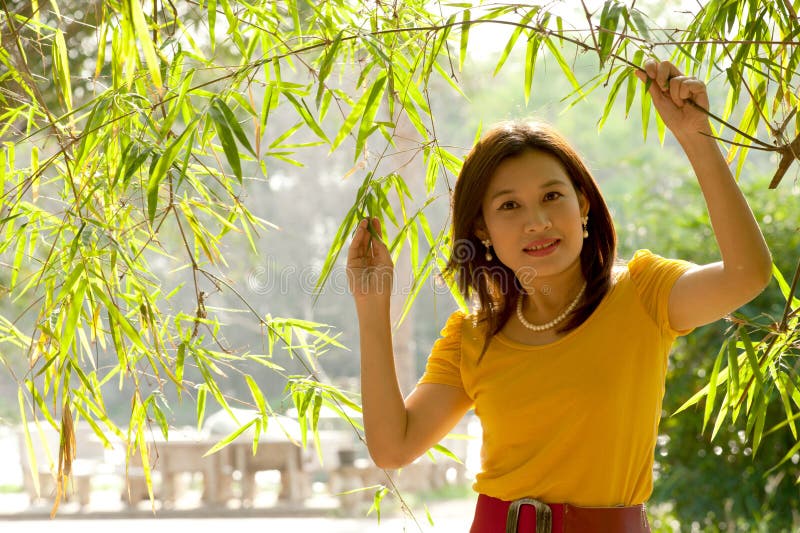 Pretty Asian woman in yellow dress .