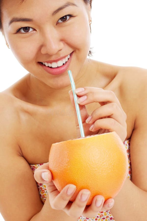 Pretty asian young woman with grapefruit