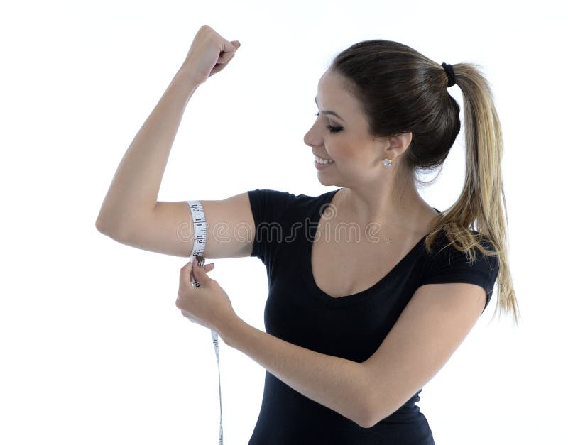 Woman measuring her biceps stock image. Image of beautiful - 114684771