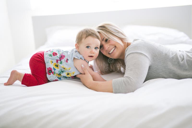 Pretty Baby Sit on Mom in Silk Bed Stock Photo - Image of caucasian ...