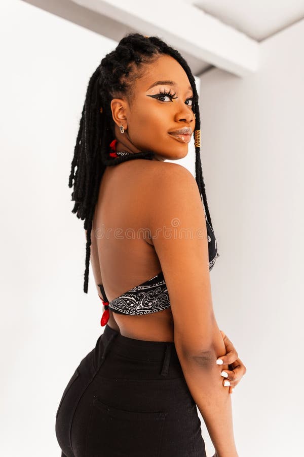 Pretty Beautiful Young Black Woman with Cool Dreadlocks with in Jeans in  Stylish Bandana Top with Open Back Near White Stock Image - Image of  dreadlocks, girl: 245283011