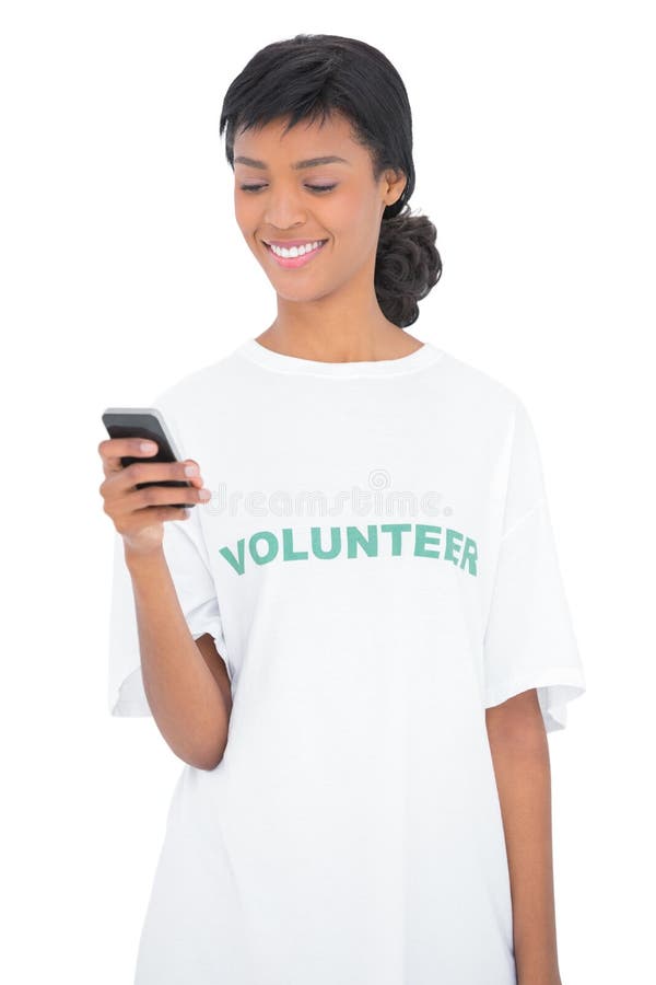 Pretty black haired volunteer texting with her mobile phone stock photography