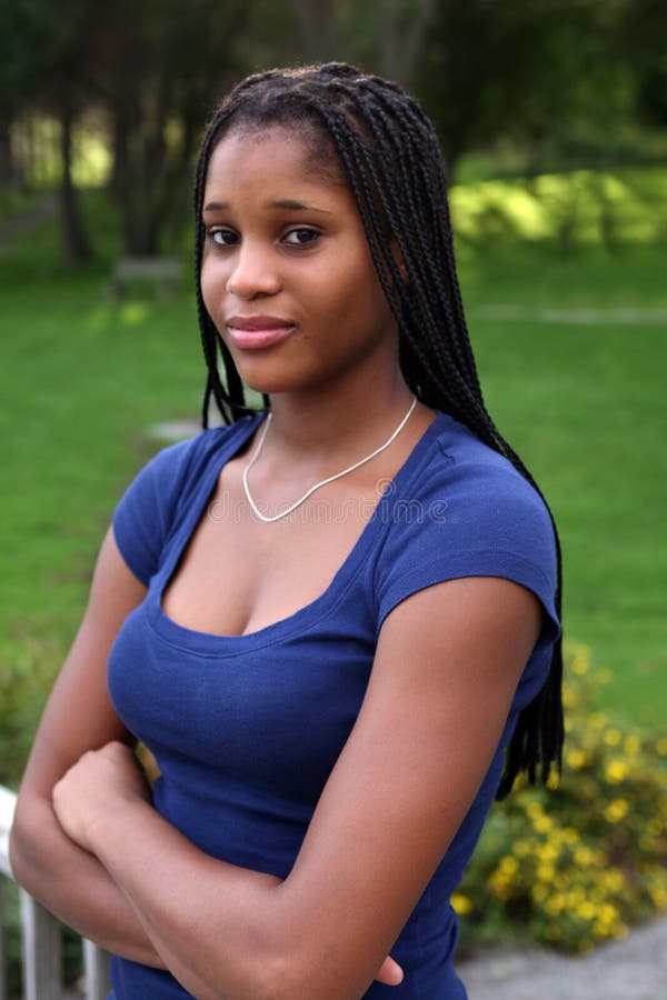 Pretty black teenage girl in a green park