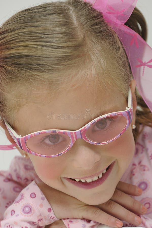 Pretty blond girl with pink sun glasses