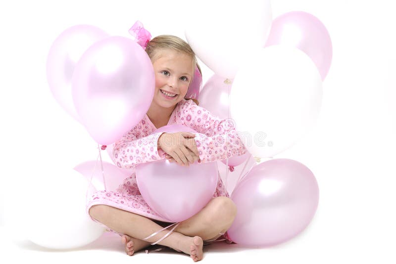 Pretty blond girl sitting between pink balloons