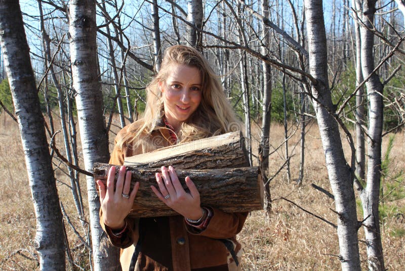 Pretty blonde carrying firewood